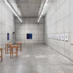 *"Fulgor Atlântico"* by Tiago Sant'Ana features an installation with the *Itutu* series in cobalt blue and a video exploring speech and listening. The works address themes of memory, identity, and Yoruba cultural traditions, connecting history, aesthetics, and Afro-diasporic resistance, highlighting the enduring influence of the African diaspora in Brazil.